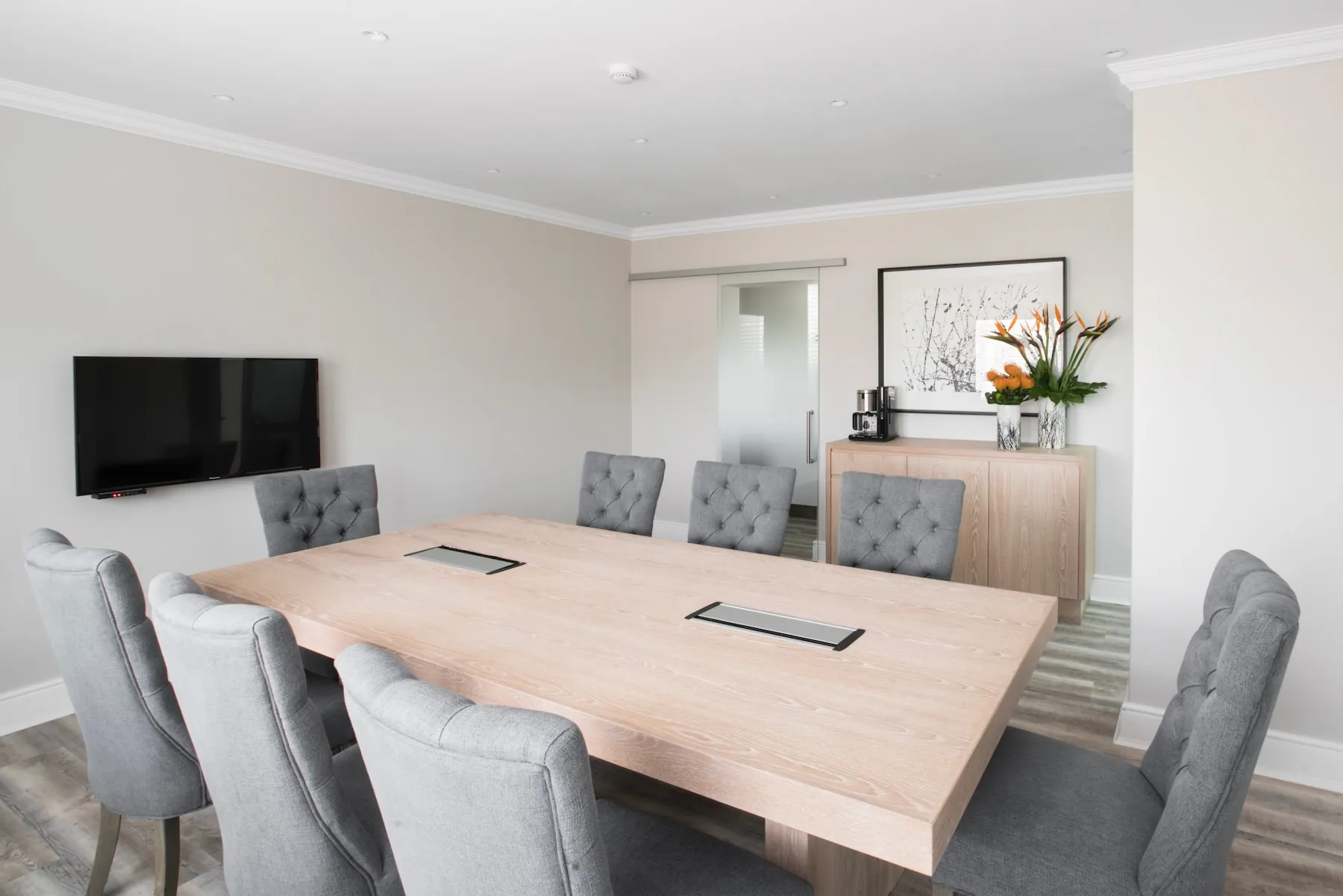 Conference room — boardroom with seating for 8, smart TV and natural decor | Studio Stay on Sixty6 boutique hotel & accommodation in Sandton